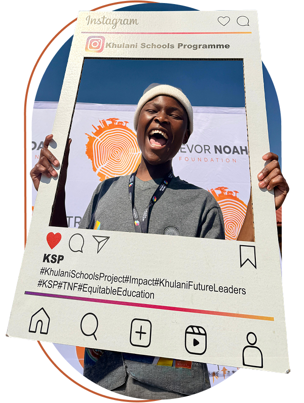 A student holding a Khulani Schools Programme social frame